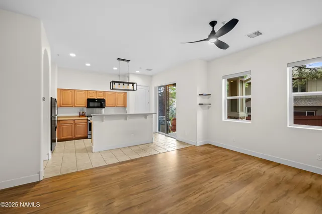 a view of a kitchen with furniture and wooden floor