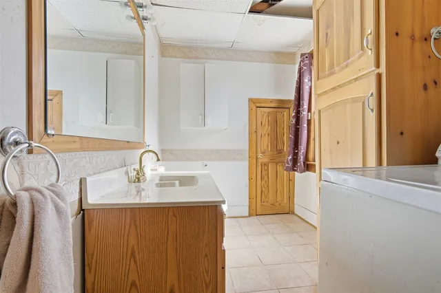 a bathroom with a sink a mirror and a shower