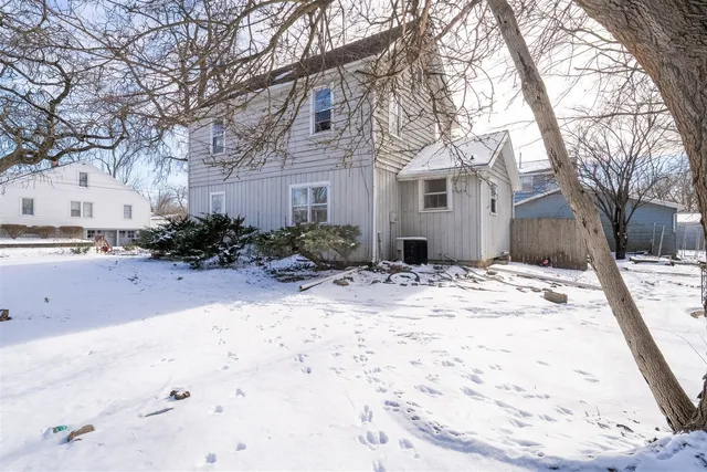 a view of a yard covered with snow in front of house