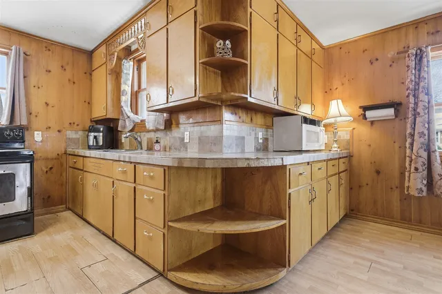 a bathroom with a sink a toilet and mirrors