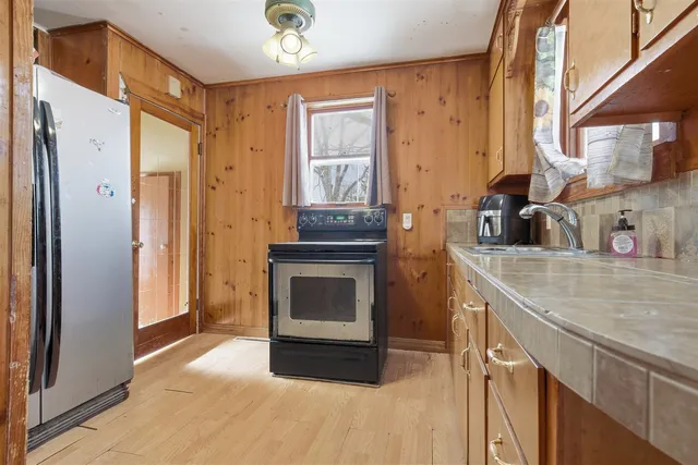 a kitchen with granite countertop a stove and a refrigerator