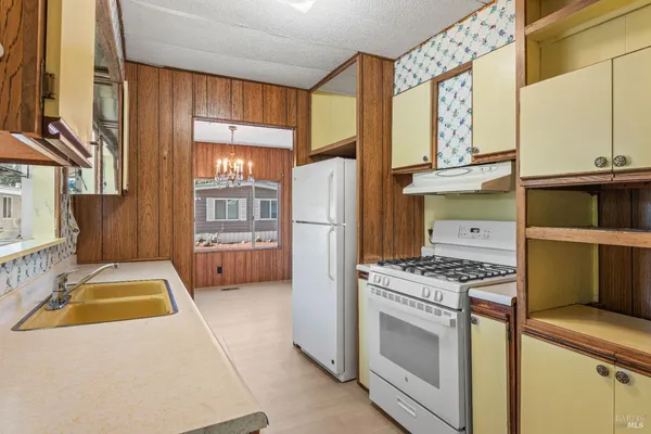 a kitchen with stainless steel appliances granite countertop a stove a refrigerator and a cabinets