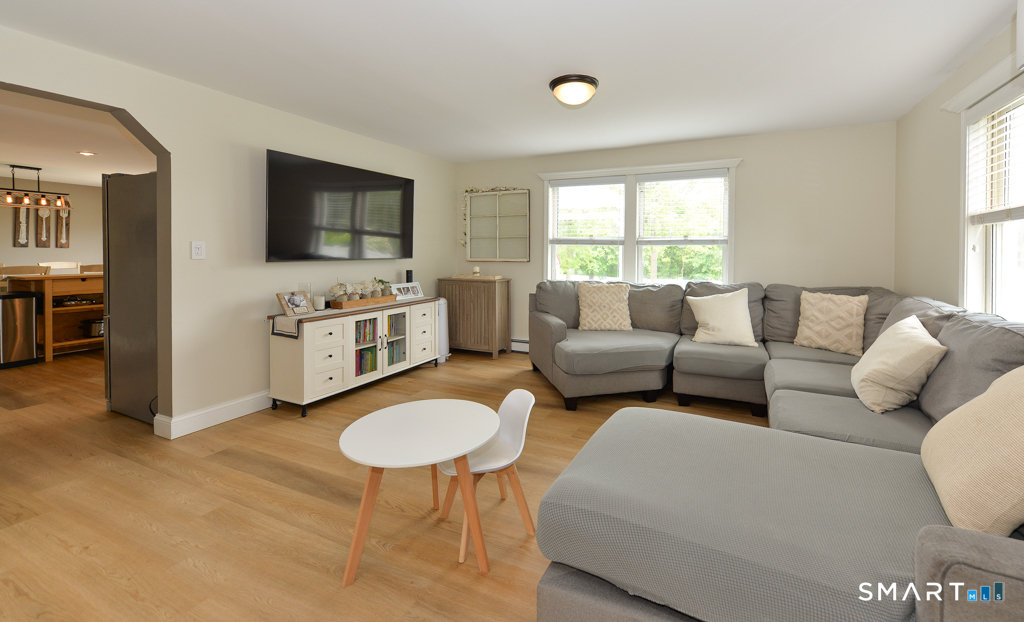 109 Harrison Lane Bethlehem, CT 06751 - Photo 7 of 28 a living room with furniture a flat screen tv and a couch
