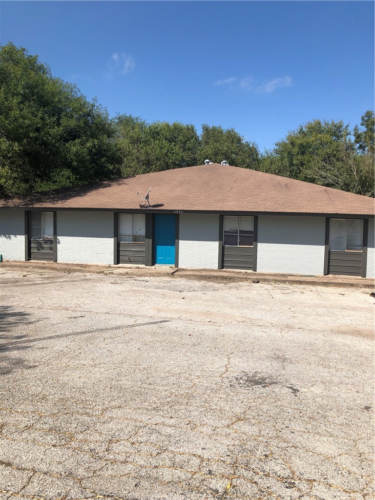 6502 South 1st Street, Unit 102 Austin, TX 78745 - Photo 5 of 26 a house with trees in the background