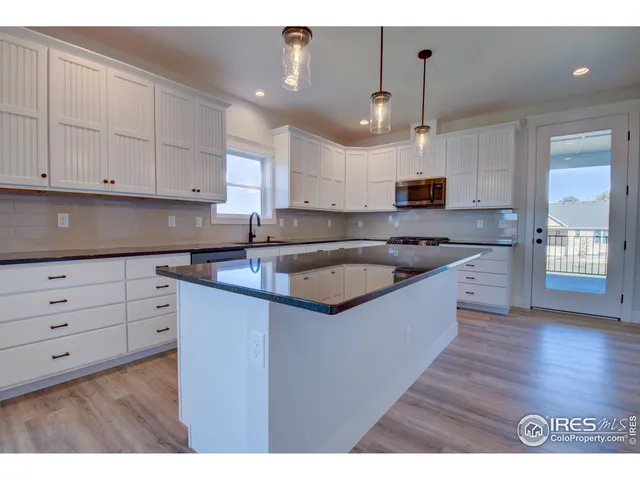 a kitchen with kitchen island a sink stainless steel appliances and cabinets