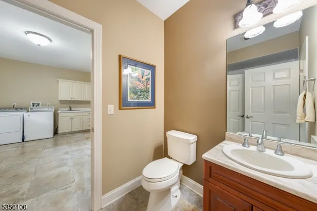 a bathroom with a sink a toilet and mirror