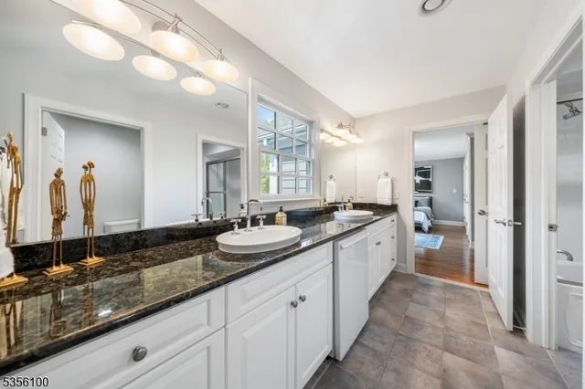 a large bathroom with a double vanity sink and a mirror