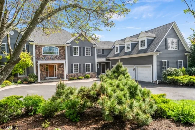 a front view of a residential houses with yard and green space