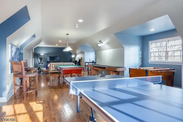 a view of a kitchen with kitchen island a large counter space a sink appliances and a living room view