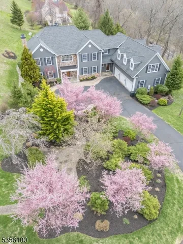 a front view of house with yard and trees in the background