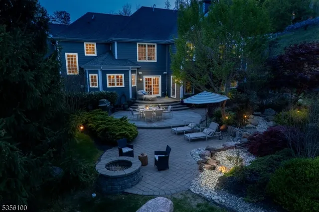 a view of a house with yard and sitting area