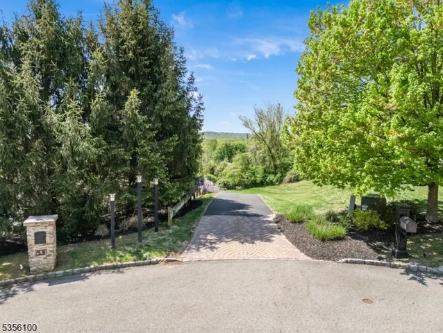 a view of a street with a house in the background