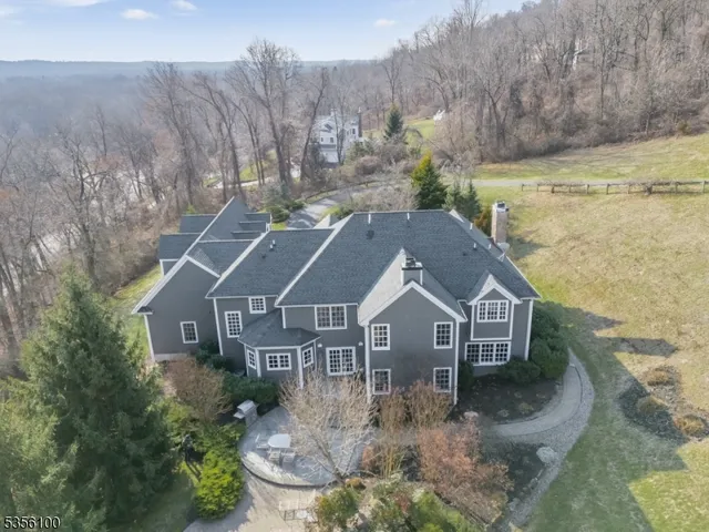 a aerial view of a house next to a yard with green space