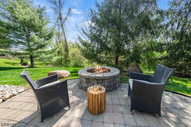 a view of a patio with a table chairs and a fire pit