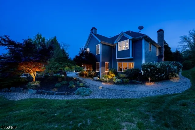 a view of house with yard and outdoor seating