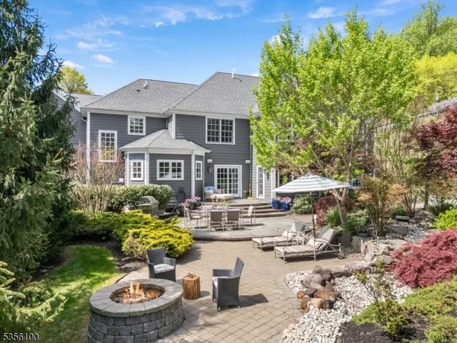 a front view of a house with a yard and fountain