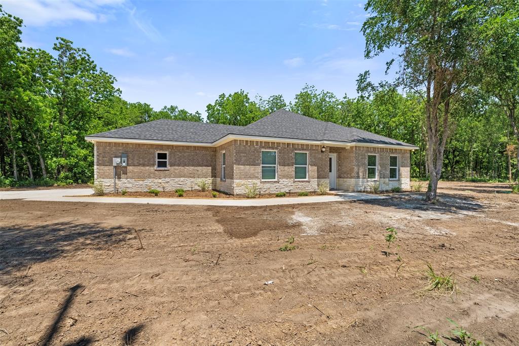 1011 Southeast County Road Corsicana, TX 75109 - Photo 3 of 40 a front view of a house with swimming pool