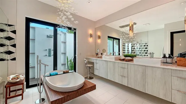 a bathroom with a double vanity sink a toilet a mirror and shower