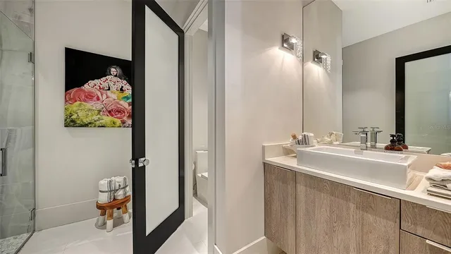 a bathroom with a sink mirror and vanity