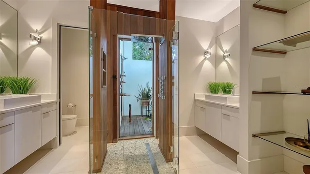 a bathroom with a glass shower door and a sink
