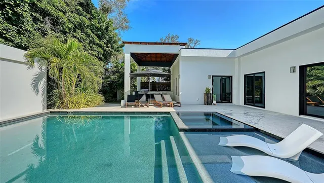 a view of swimming pool with chairs