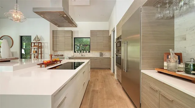 a kitchen with stainless steel appliances a sink stove and refrigerator