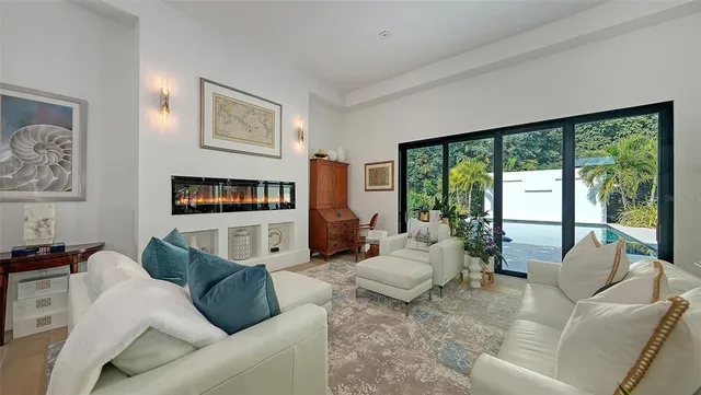 a living room with furniture large window and a flat screen tv