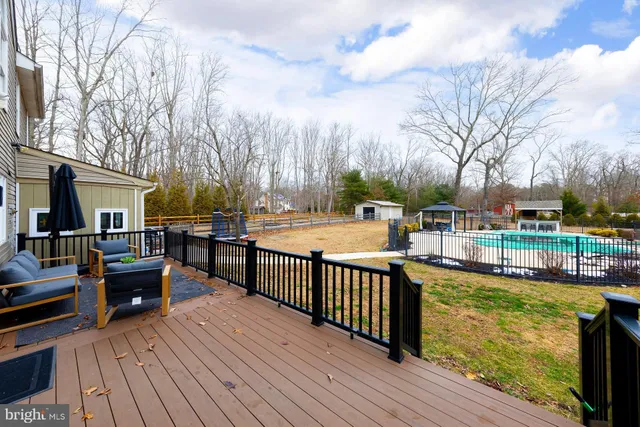 a view of a house with pool and chairs
