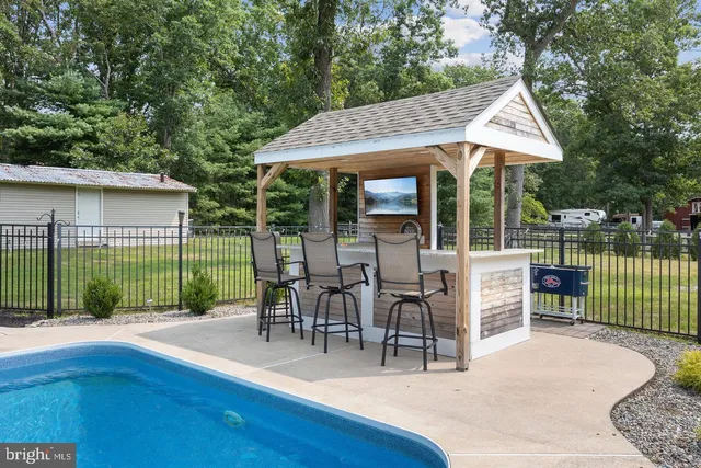 a view of a house with swimming pool and sitting area