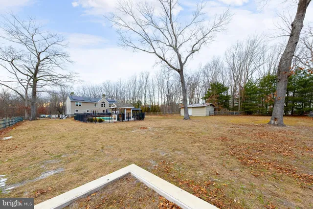 a living room with furniture a rug and a large window