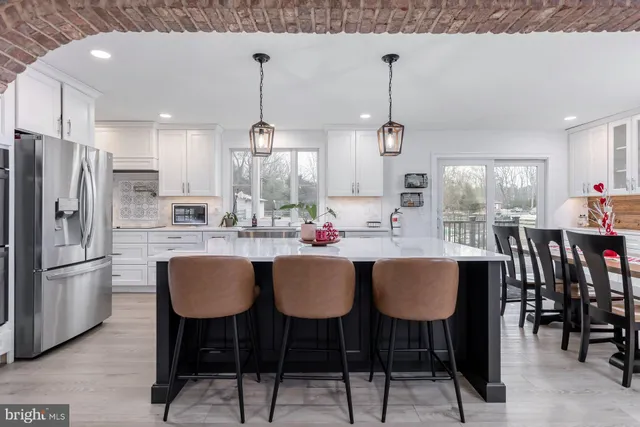 a bathroom with a granite countertop shower a sink and mirror