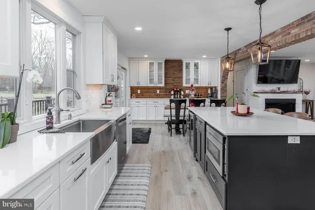 a living room with furniture a large window and a flat screen tv