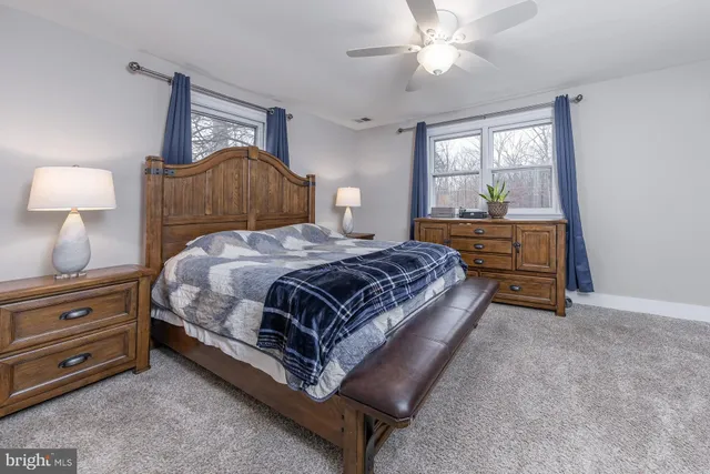 a living room with a bed furniture and a dresser