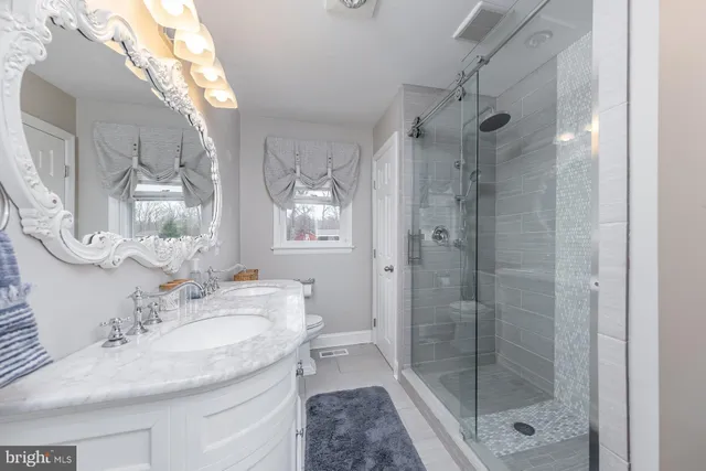 a spacious bedroom with a bed and a chandelier