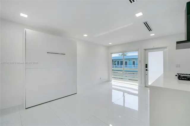 a bedroom with a bed and a large mirror