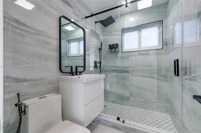 a bathroom with a shower and a glass door