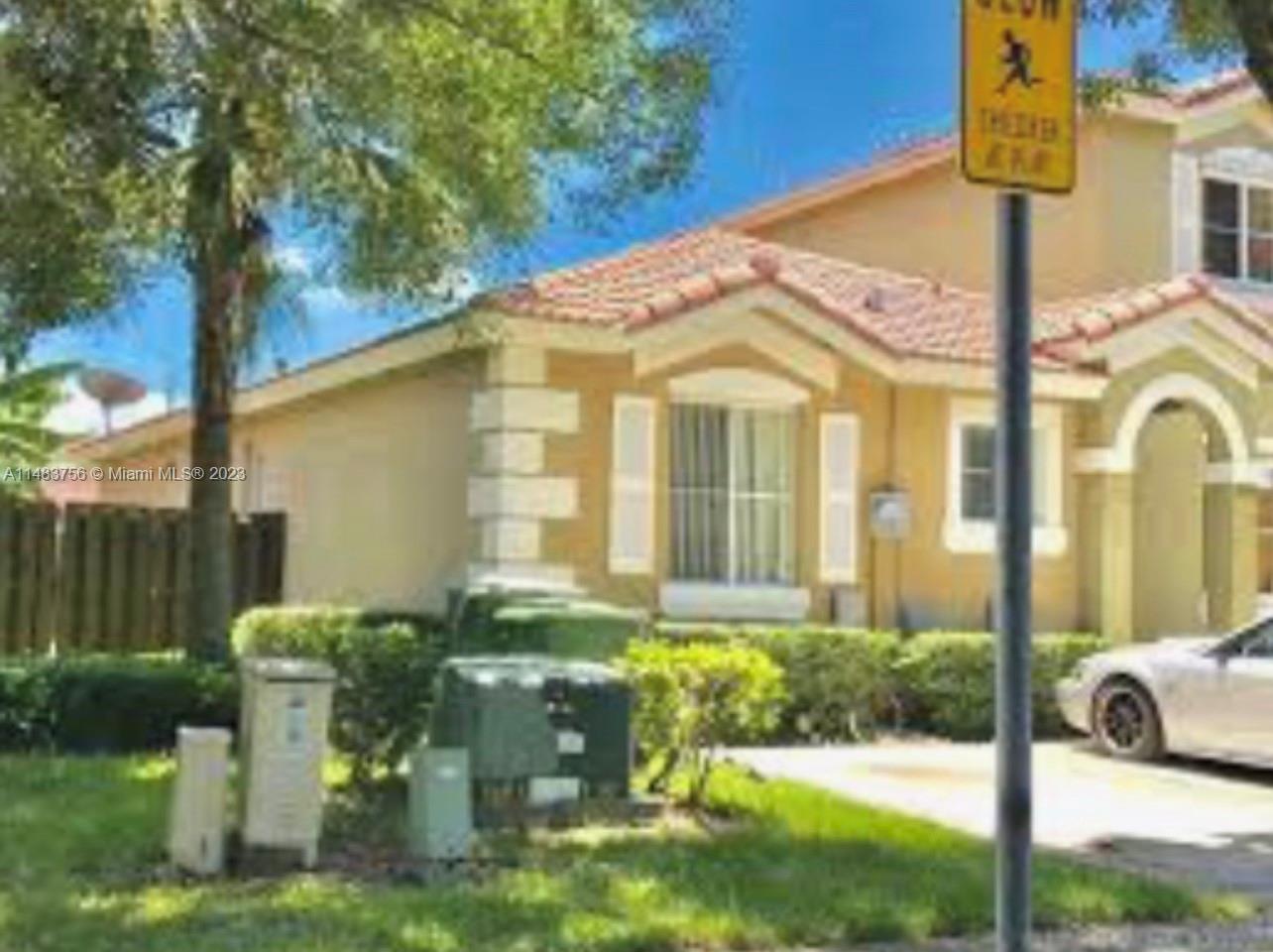 1548 Southwest 2nd Street Homestead, FL 33030 - Photo 2 of 15 a front view of a house with garden