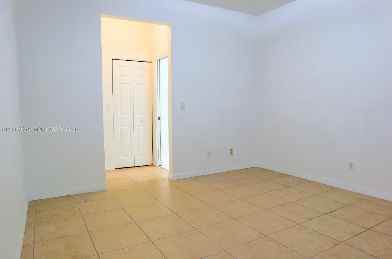 1548 Southwest 2nd Street Homestead, FL 33030 - Photo 5 of 15 an empty room with a window