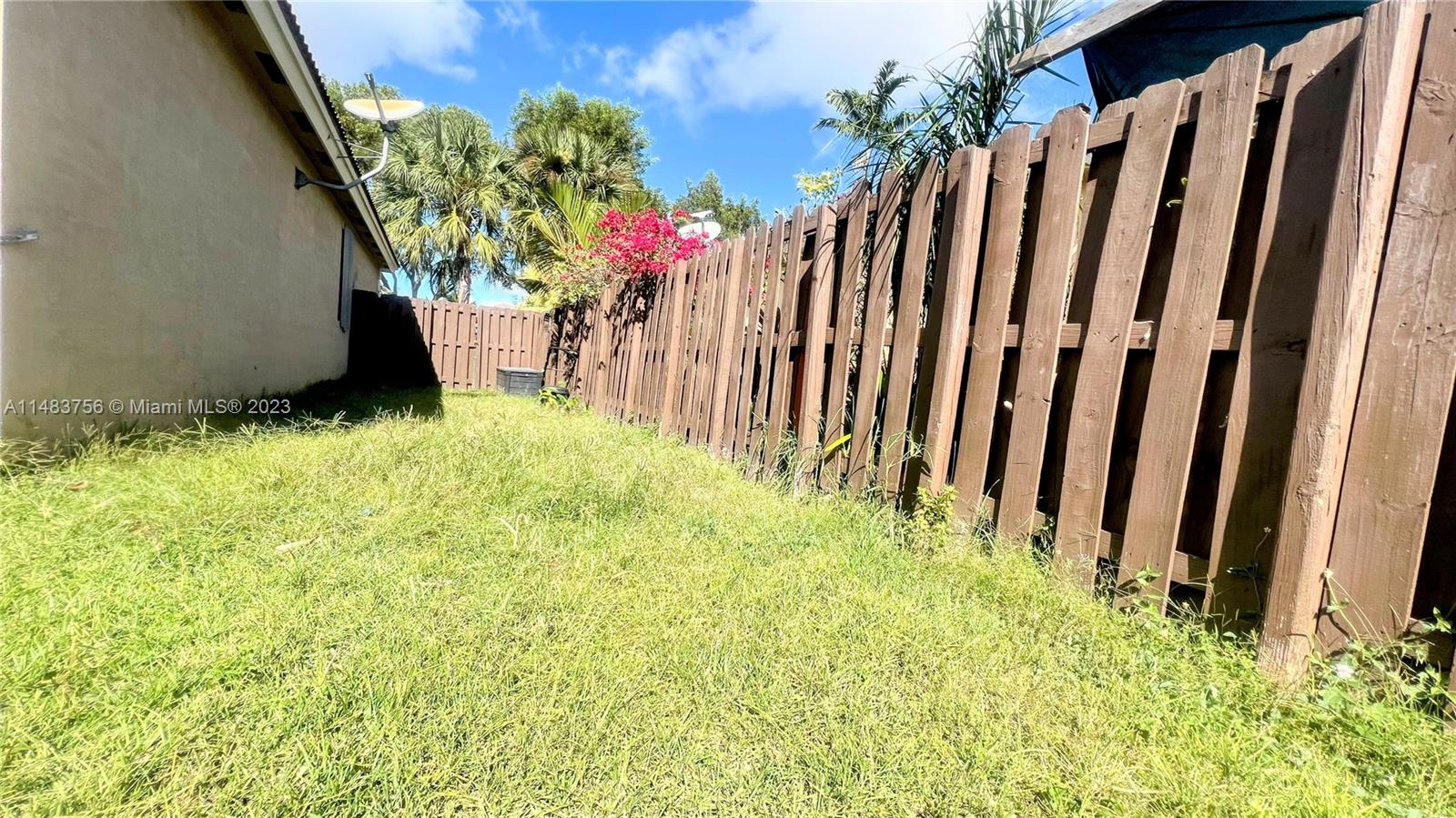 1548 Southwest 2nd Street Homestead, FL 33030 - Photo 10 of 15 a view of flower garden with wooden fence