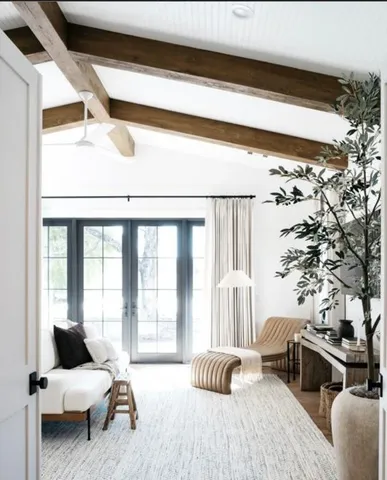 a bedroom with furniture and a large window