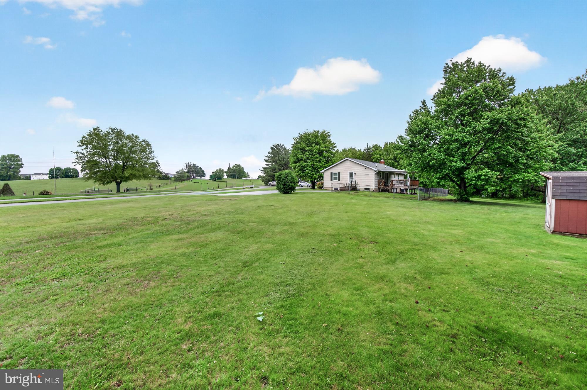 5601 Woodville Road Mount Airy, MD 21771 - Photo 45 of 54 a view of a big yard with a house and a garden