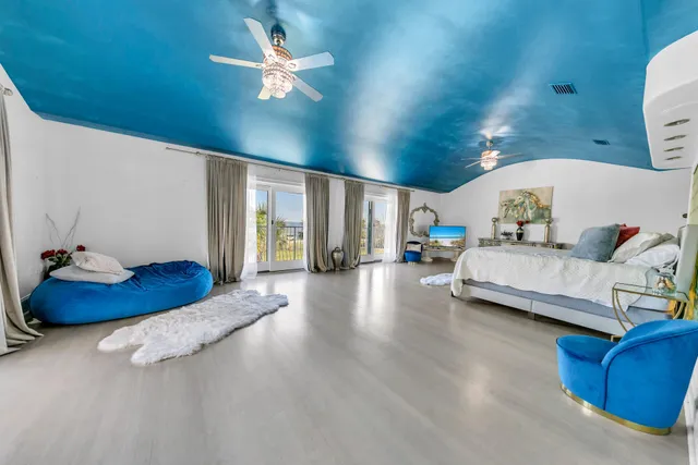 a bedroom with two beds and a chandelier