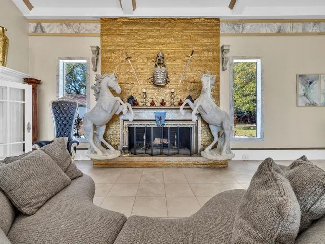 a kitchen with stainless steel appliances granite countertop a refrigerator a sink a stove and a sink