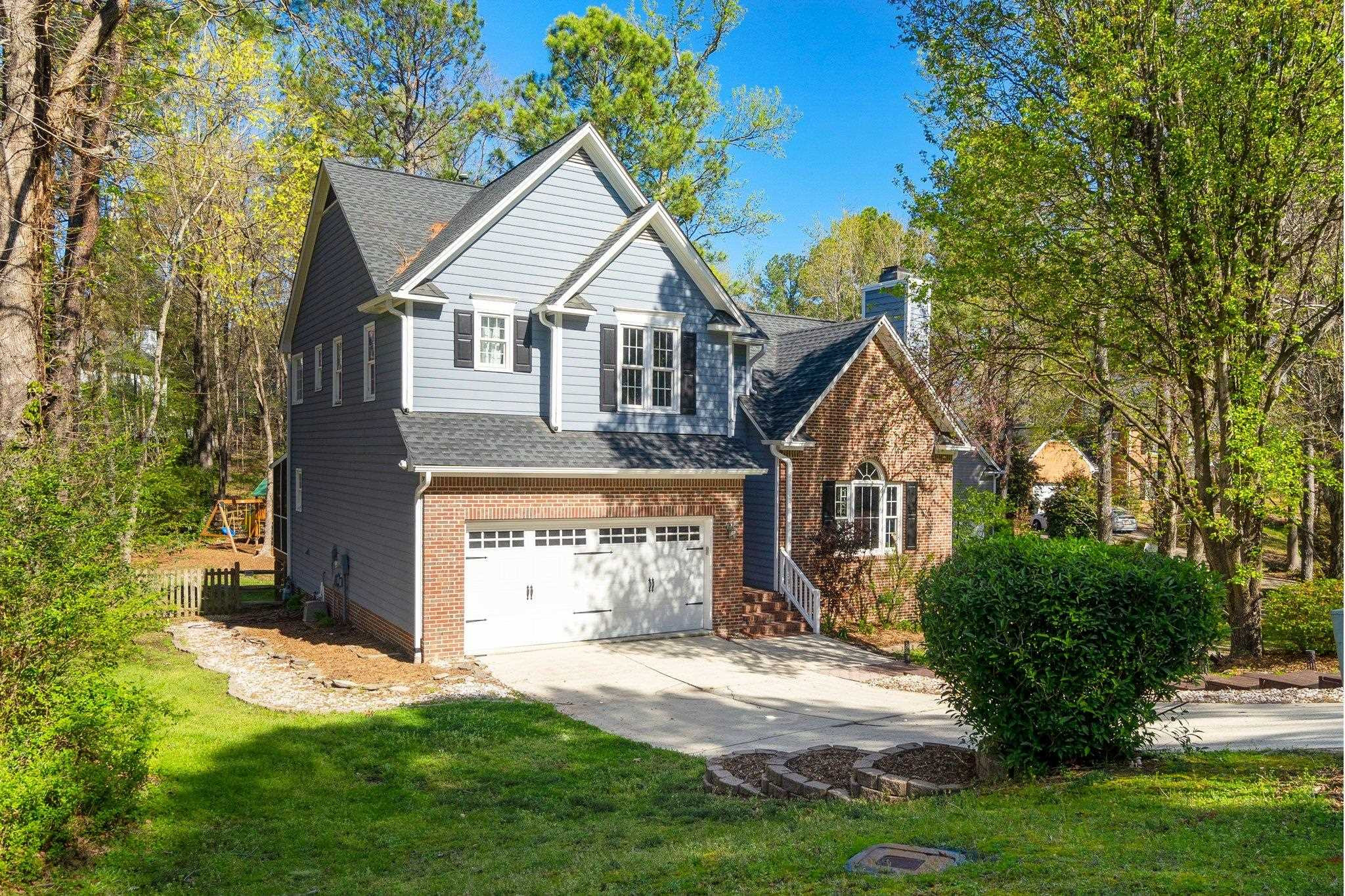 102 Waverly Place Durham, NC 27713 - Photo 2 of 12 a front view of a house with a yard and garage
