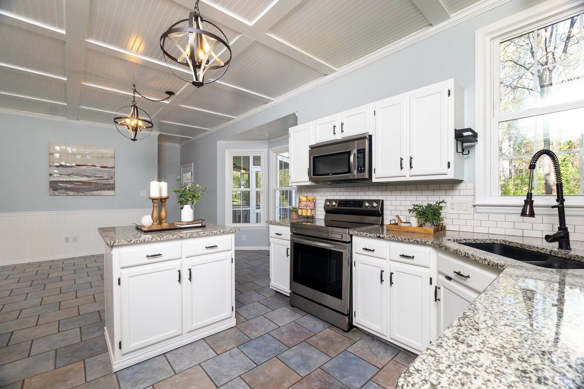 102 Waverly Place Durham, NC 27713 - Photo 5 of 12 a kitchen with granite countertop a sink stainless steel appliances and cabinets
