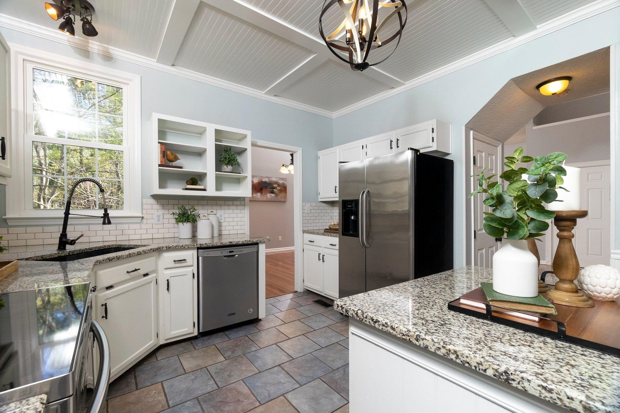 102 Waverly Place Durham, NC 27713 - Photo 6 of 12 a kitchen with stainless steel appliances granite countertop a sink a stove a refrigerator cabinets and a dining table