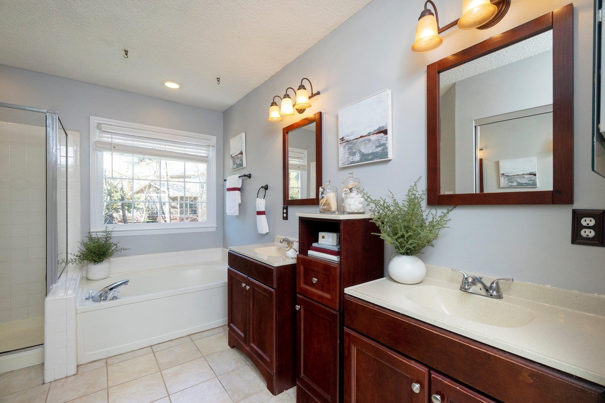 102 Waverly Place Durham, NC 27713 - Photo 8 of 12 a spacious bathroom with a granite countertop sink mirror and bathtub