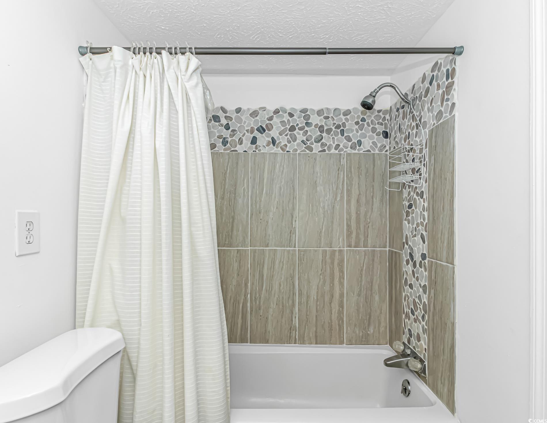 159 Offshore Drive Murrells Inlet, SC 29576 - Photo 16 of 35 Full bathroom with shower / tub combo with curtain, toilet, and a textured ceiling