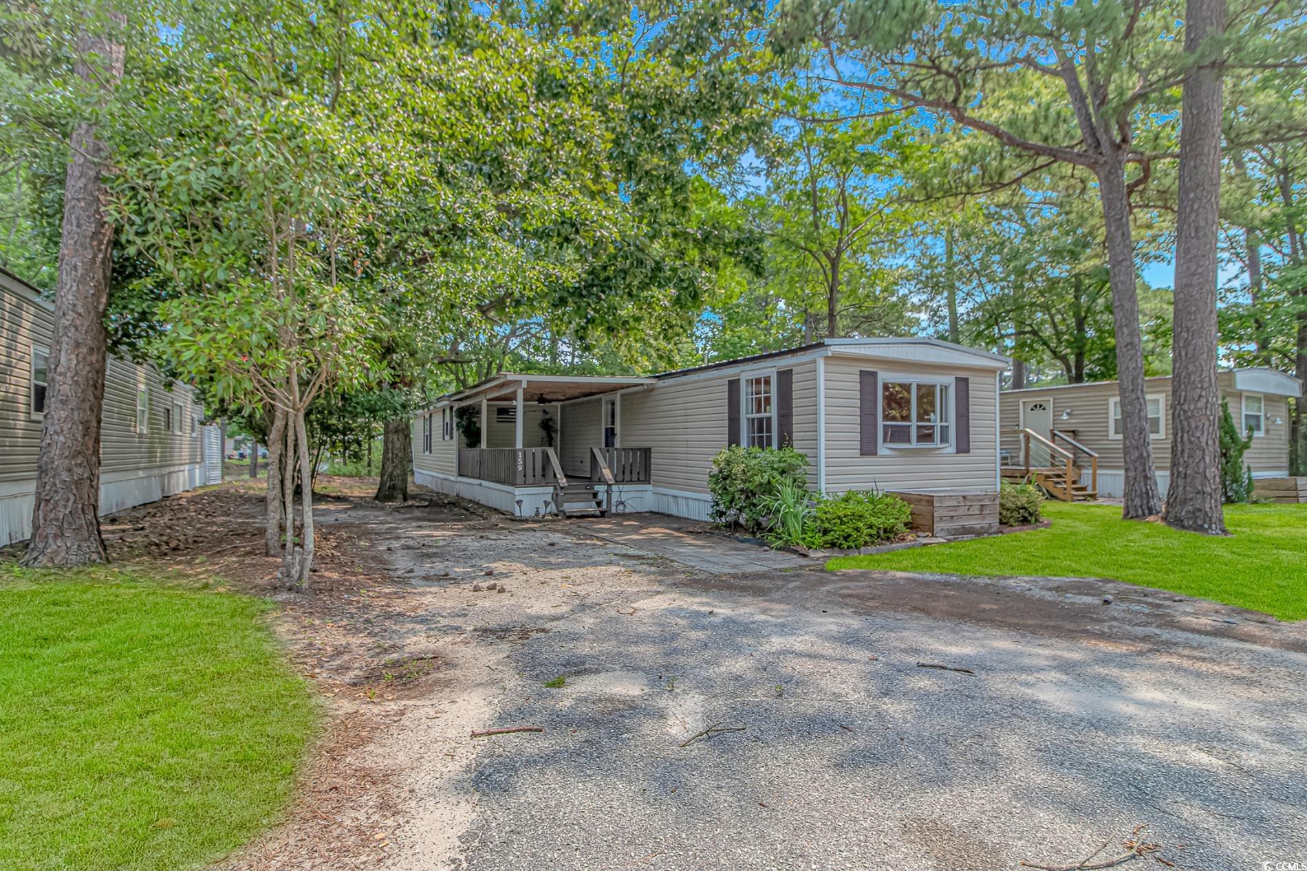 159 Offshore Drive Murrells Inlet, SC 29576 - Photo 2 of 35 Manufactured / mobile home featuring a front lawn and driveway