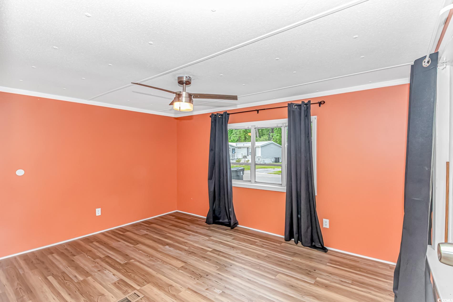 159 Offshore Drive Murrells Inlet, SC 29576 - Photo 21 of 35 Empty room featuring light wood-type flooring and ornamental molding